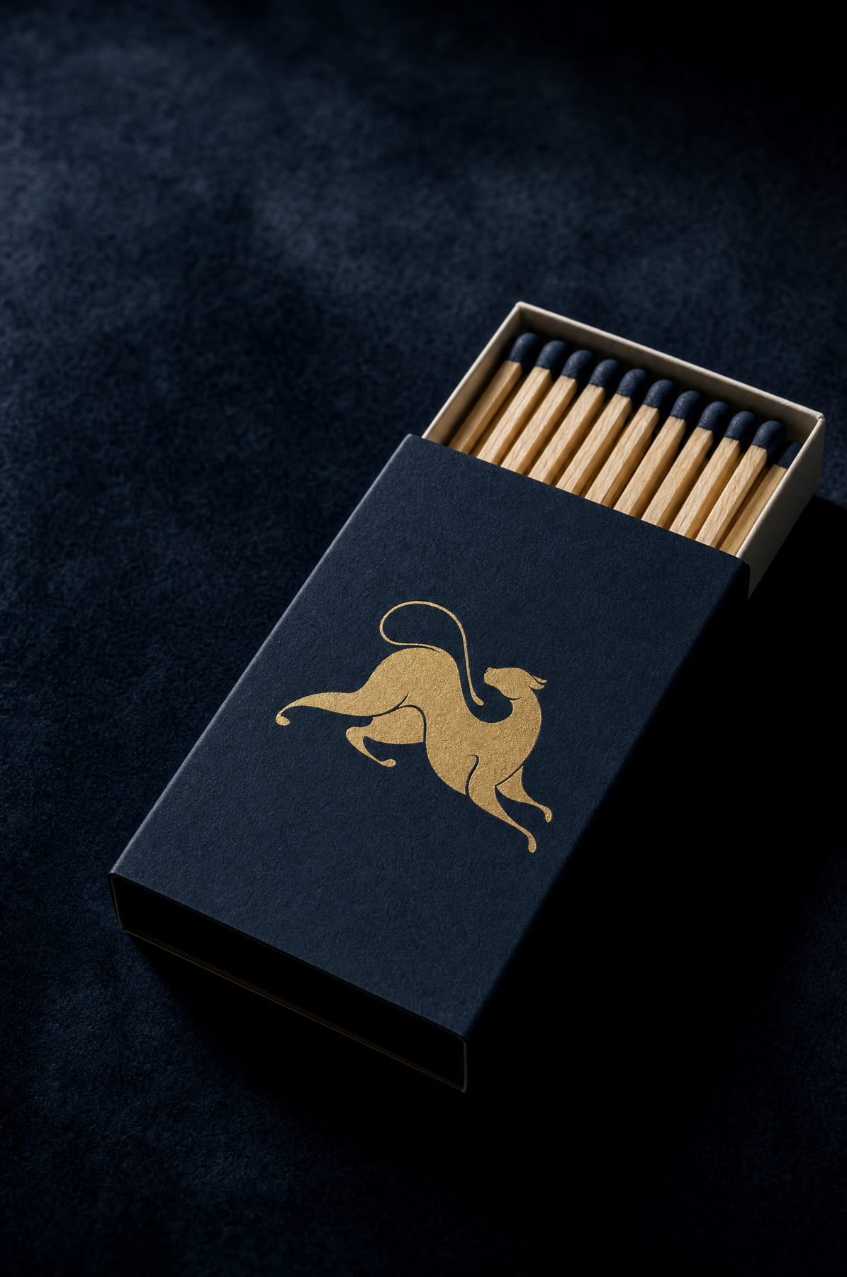 A navy matchbox with the gold leopard.